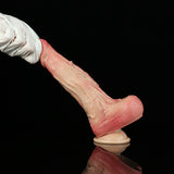 Pink realistic dildo with veining texture and rounded base, held by white glove.