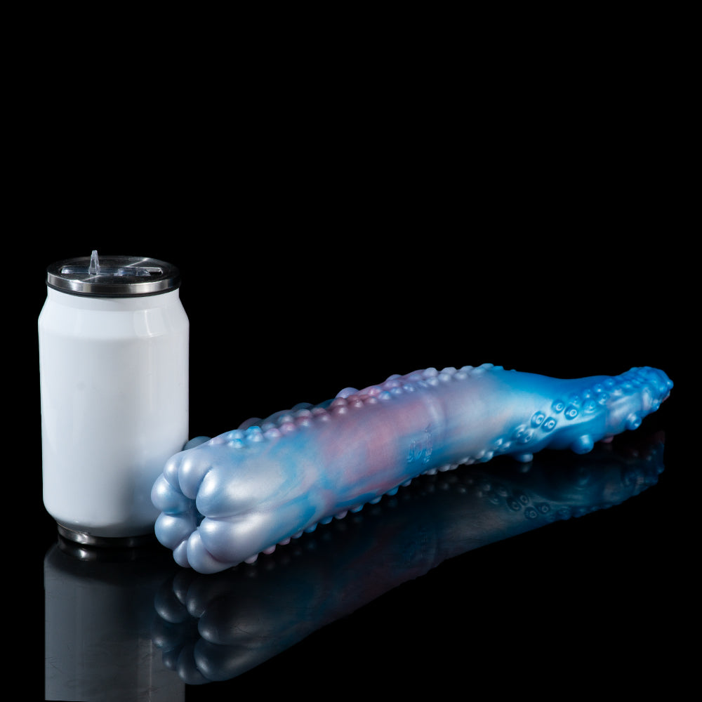 Curved blue-and-pink pleasure device beside a white cylindrical accessory