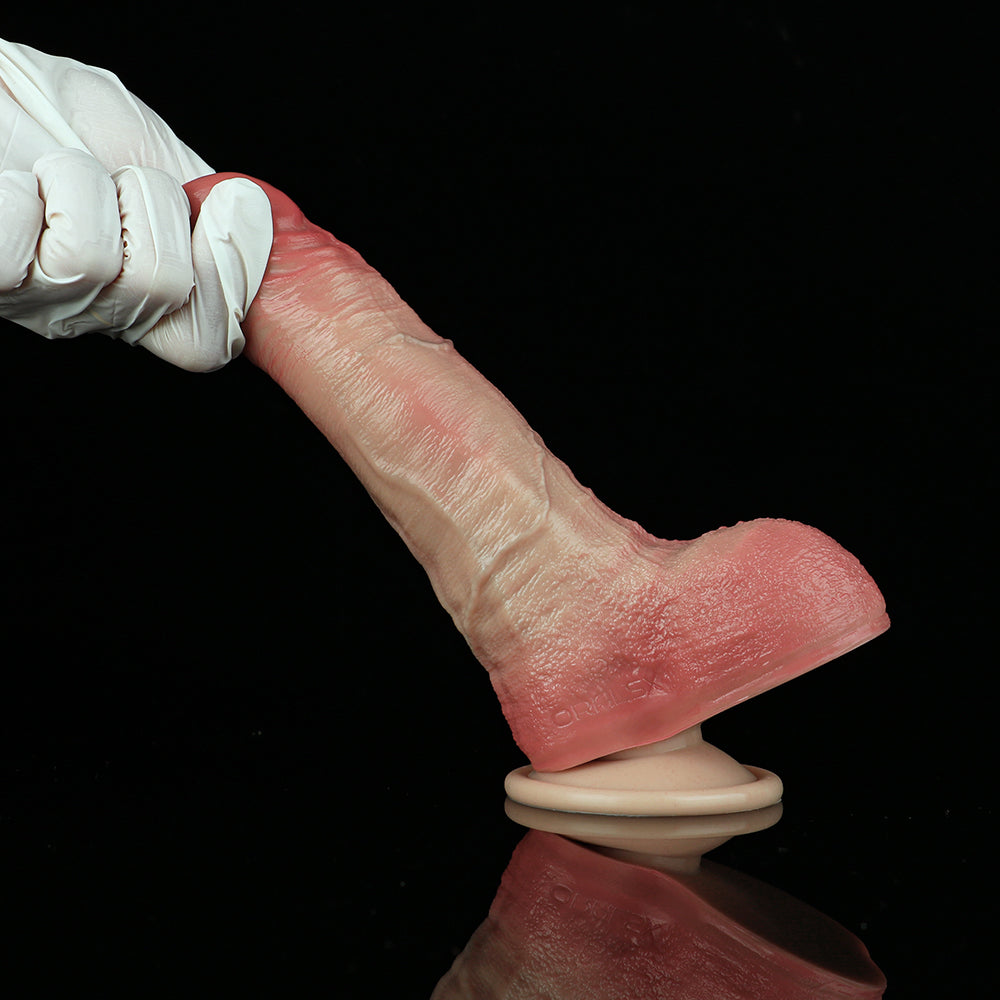 Small realistic pink dildo with suction cup base, side view.