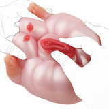 Pink pig-shaped fleshlight held by white-gloved hands, red inner channel visible
