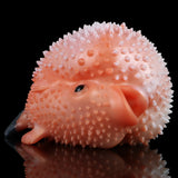 Pink spiked animal stroker with face details and opening, close-up