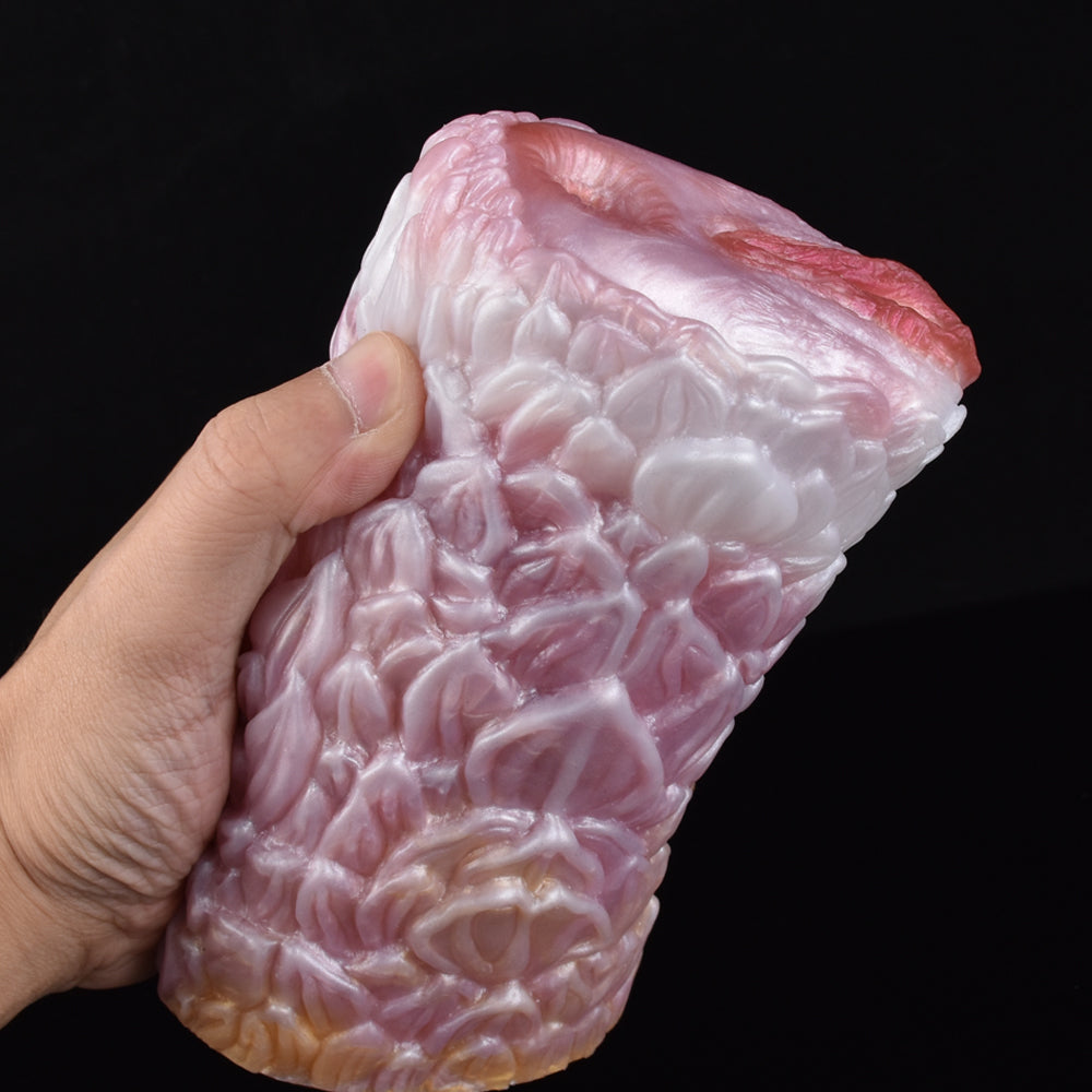 Canine fleshlight stroker angled view showing pale pink ridged surface.