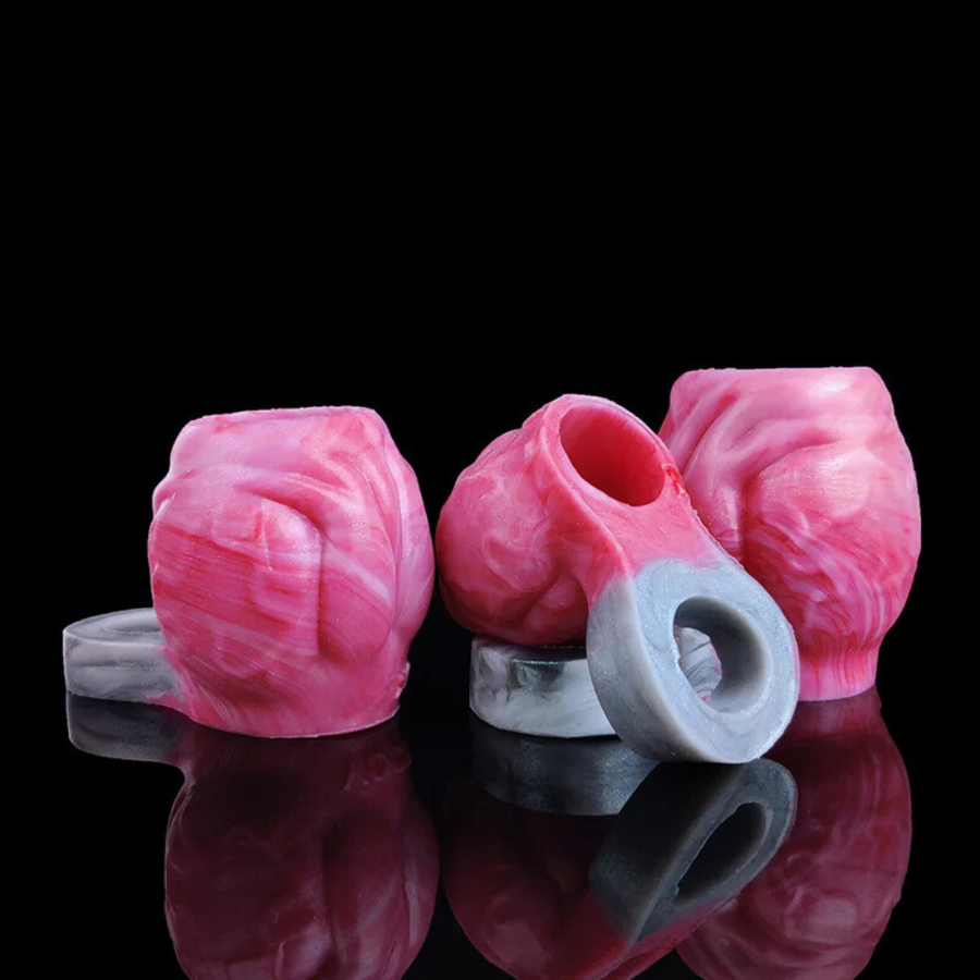 Pink and gray silicone cock ring set with gray loop, side angle view