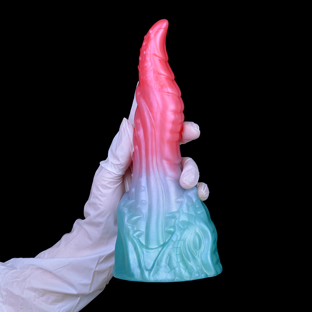 Pink dragon-style tip with light-blue textured base, viewed from back with glove.