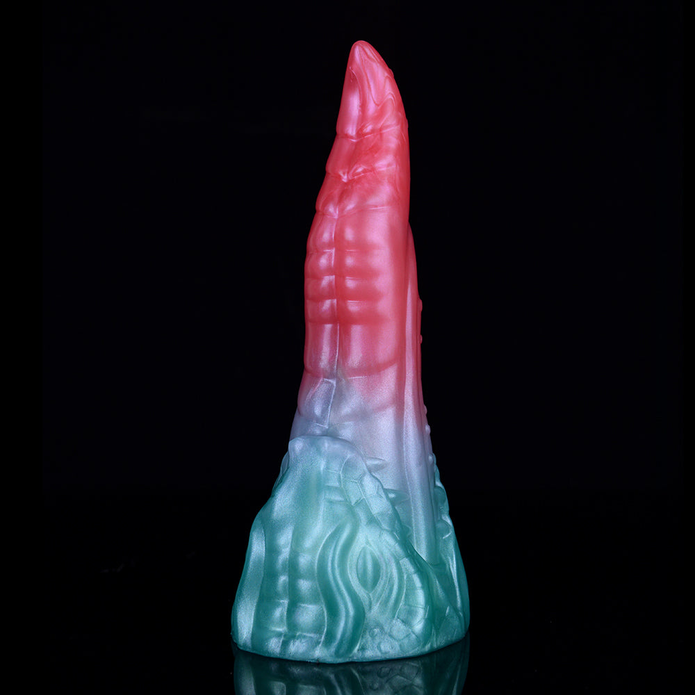 Upright view of pink tip and light-blue dragon-scale textured base on dildo.