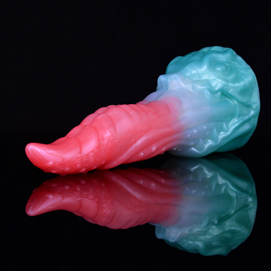 Pink and teal dragon-themed sex toy with ridged, tapered shape and flared base.