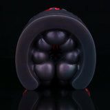 Close-up of black rounded tip with bulbous bumps on a pleasure toy.