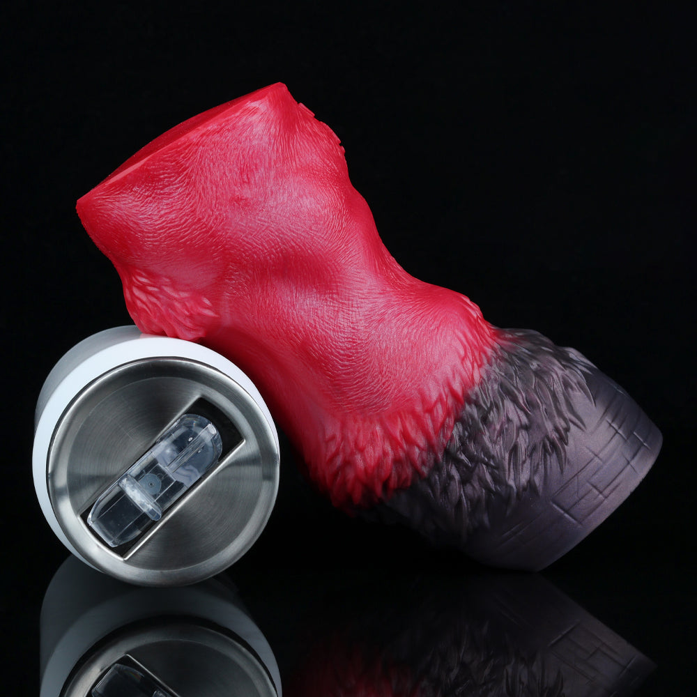 Red and black pleasure toy with textured red top and metal-capped base.
