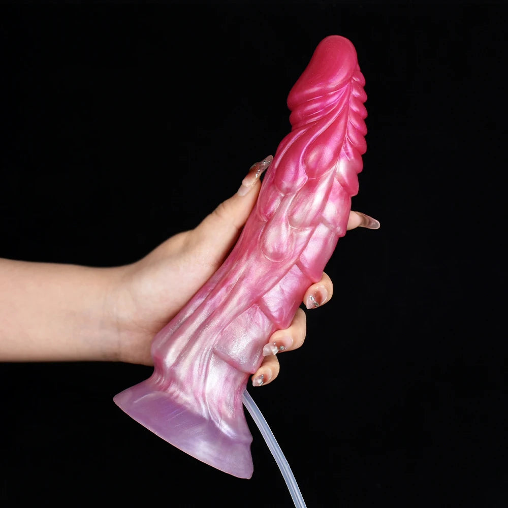 Rosa Fantasy-Dildo, von unten gehalten, mit Flügel-Textur und breitem Ende