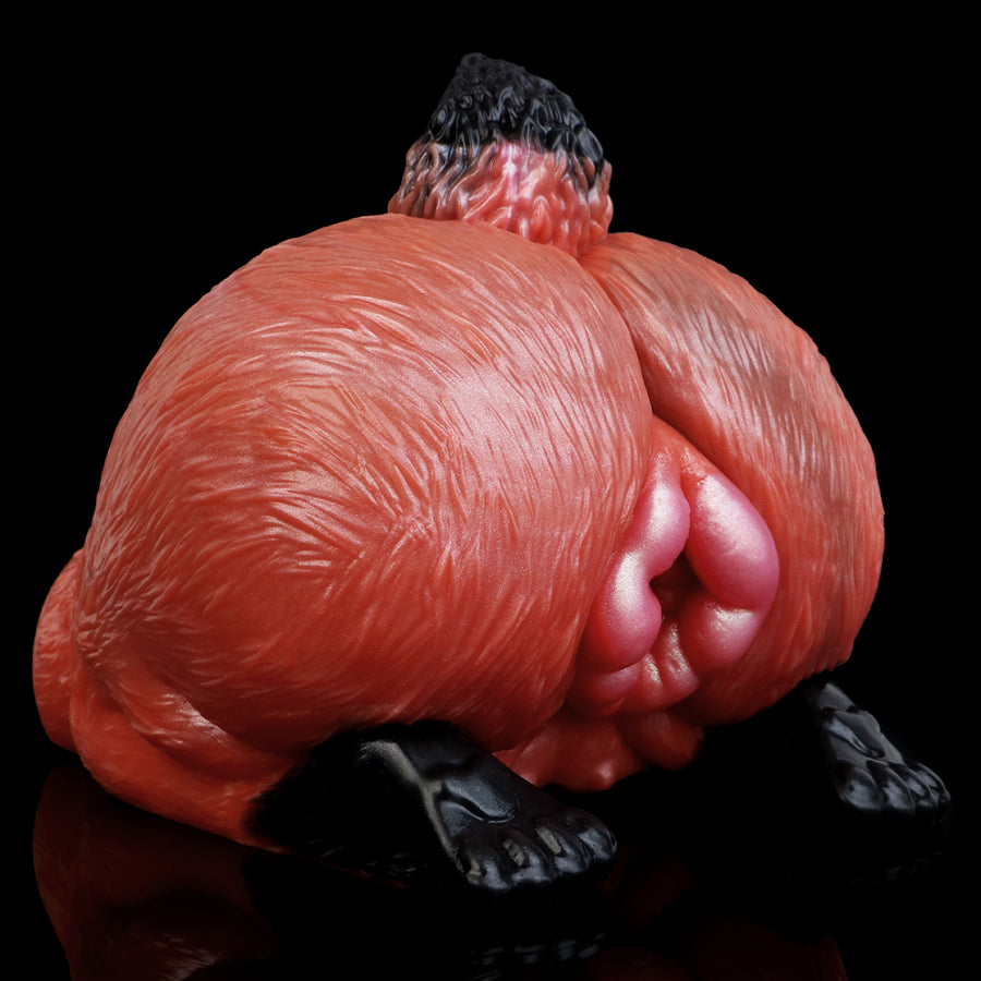 Red fleshlike animal sex toy angled view with black paw feet and opening detail
