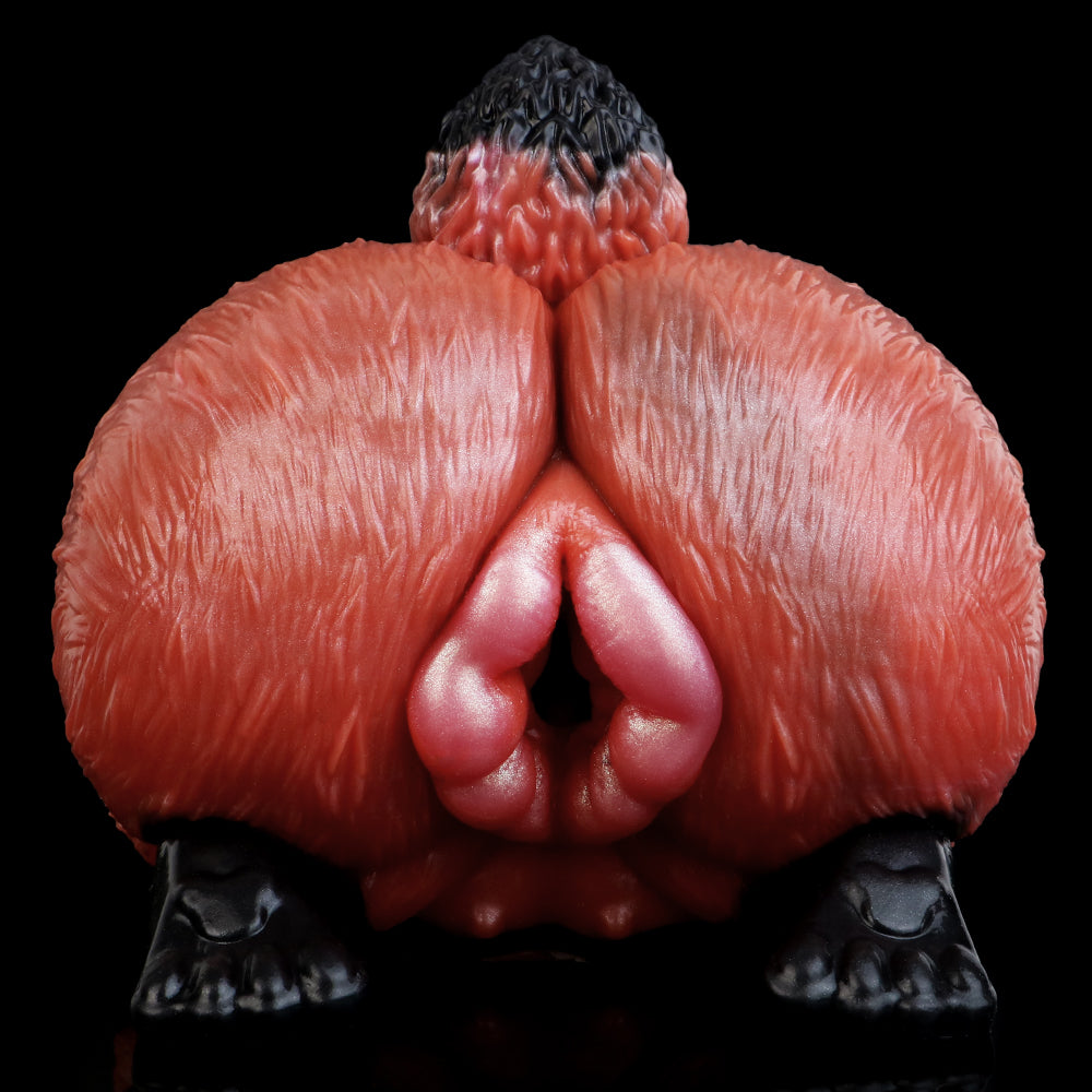 Red animal-themed sex toy insert showing central opening, textured surface, black pads