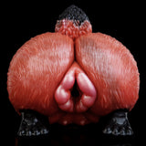 Red animal-themed sex toy insert showing central opening, textured surface, black pads