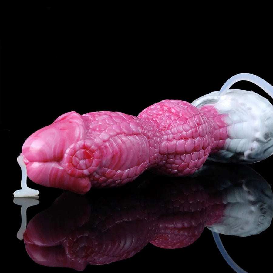 Pink textured silicone dildo lying down with white base and clear tube