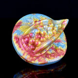 Rhea Fantasy Grinder toy—round base with octopus head and colorful raised details