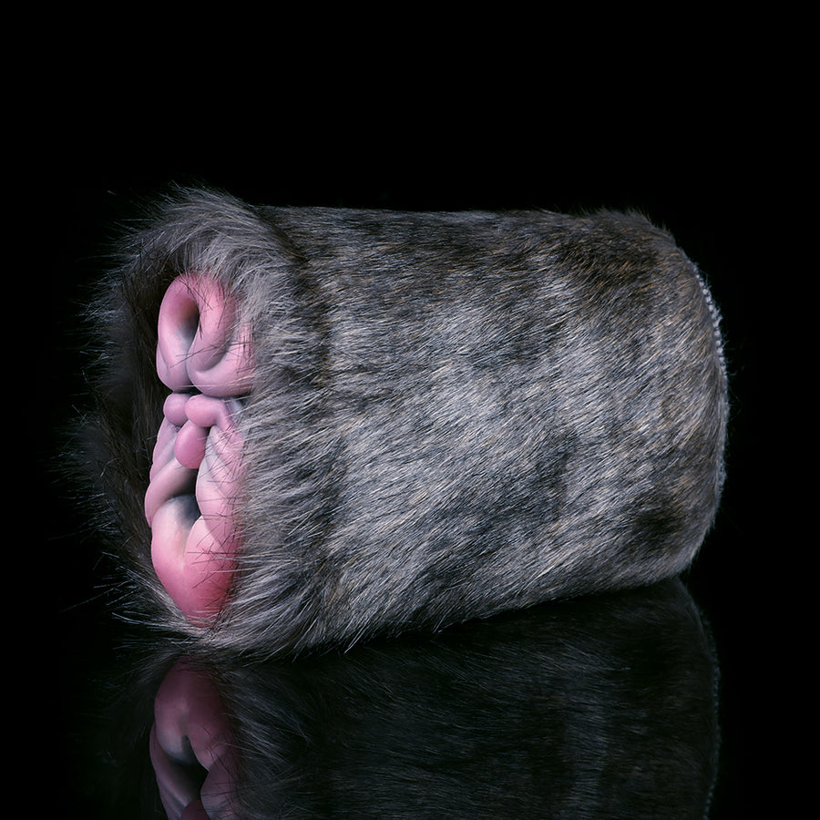 Gray furry sex toy with pink internal insert and rounded outer shell