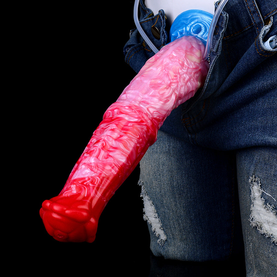 Inflatable dildo toy in red-pink, partially shown against blue jeans