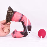 Close-up of horse-shaped dildo base and curve, marbled pink and dark, textured brown base