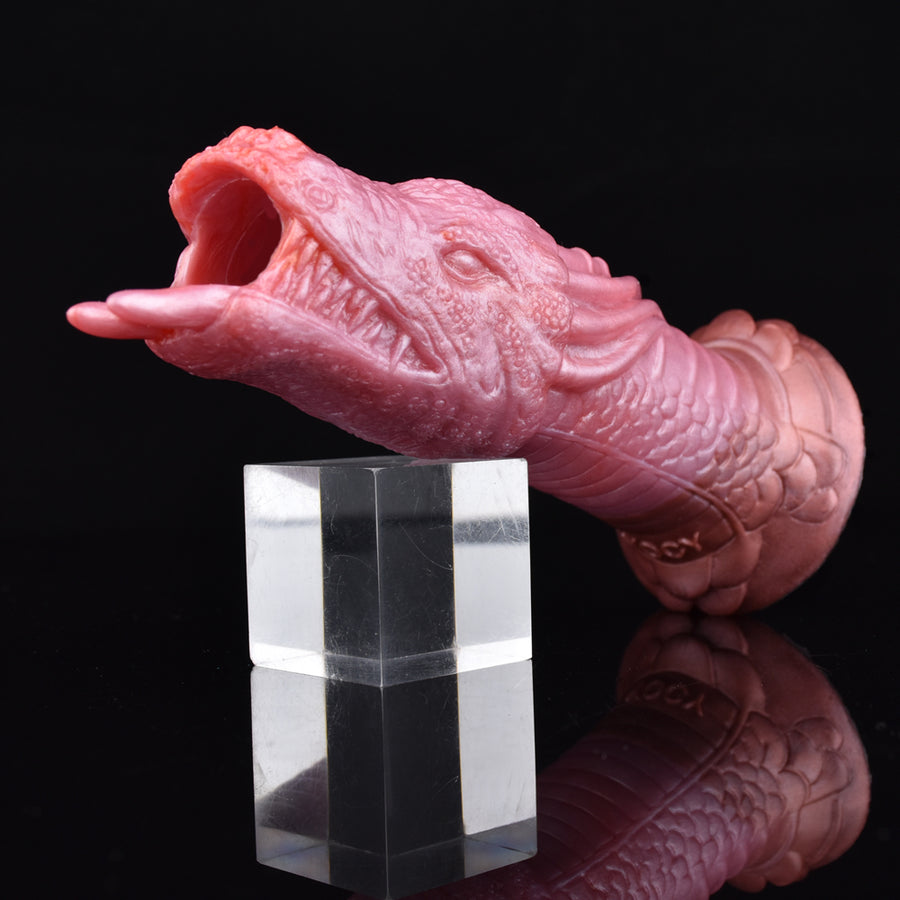 Red-pink dragon penis sheath with scaled body and horned open-tip design.