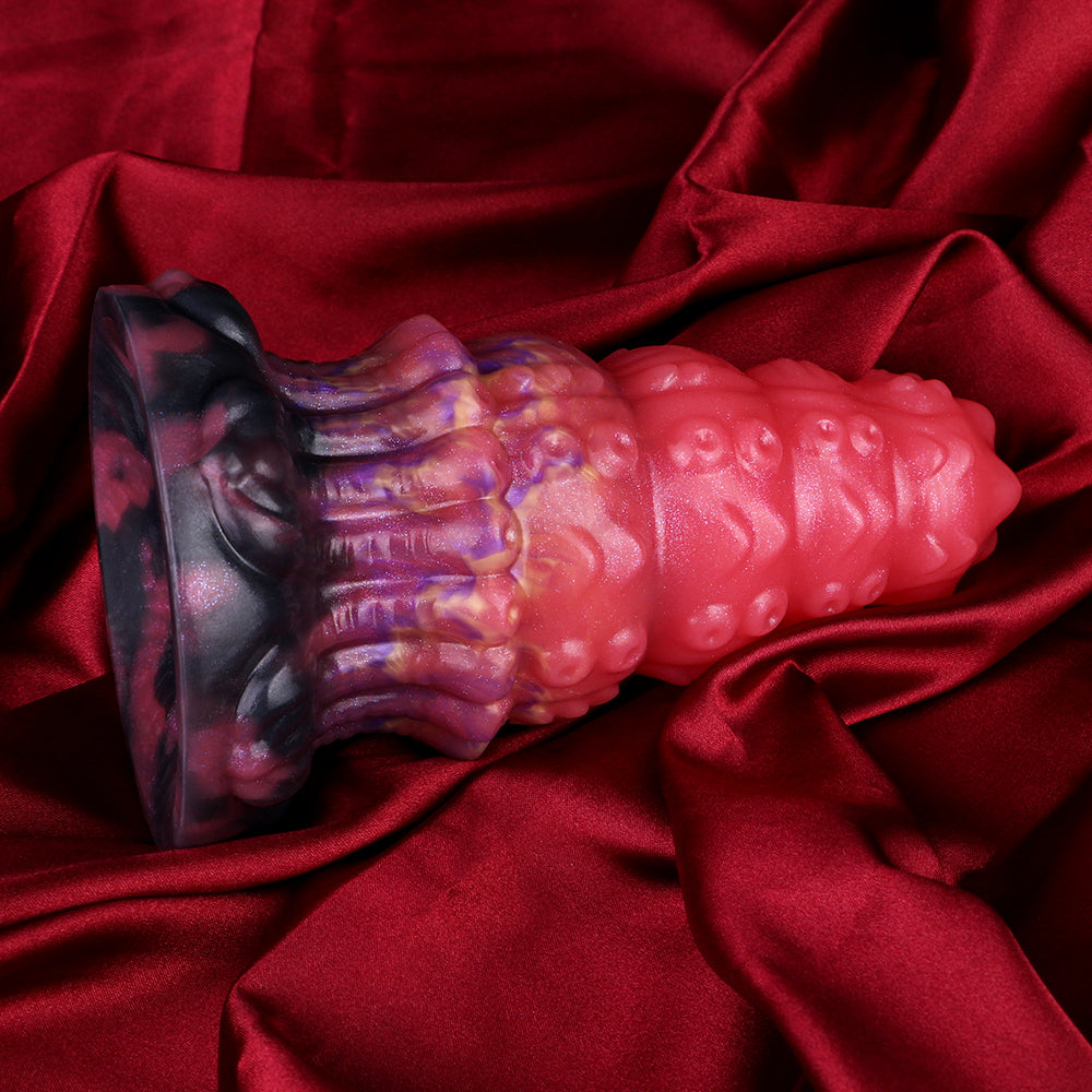 Alien anal plug: glossy pink body with purple/black ridges and thick base