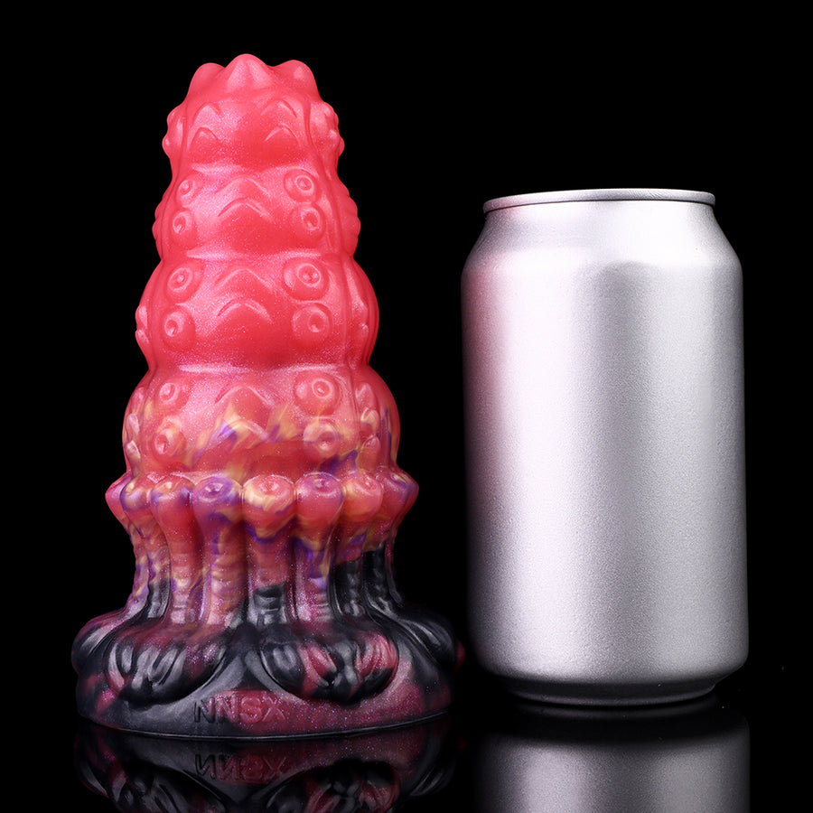 Ribbed alien anal plug standing next to a silver can for size comparison
