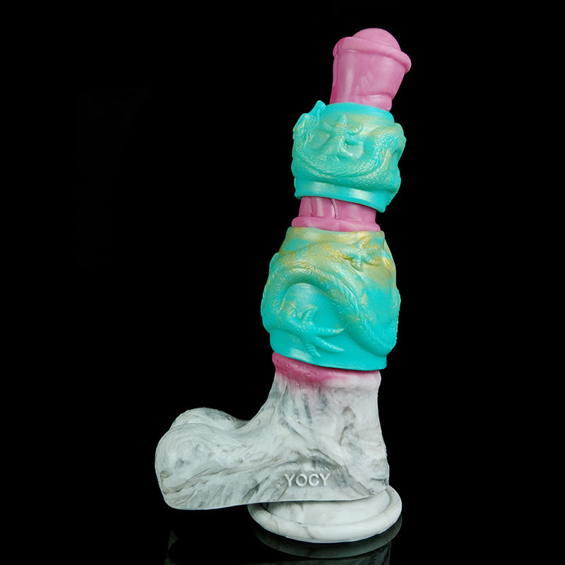 Layered view of dragon-knot penis sheath extender: pink tip, teal sleeve, white base