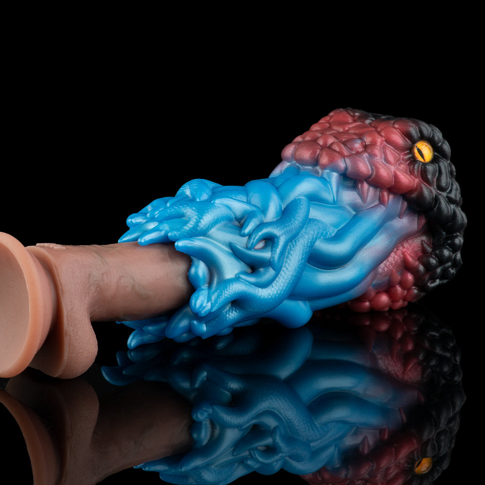 Textured silicone toy held in hand, blue ridged surface with maroon ribbed end