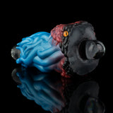 Two-tone textured silicone toy with blue ridged front and maroon back, black rounded end