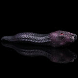 Serpentress fantasy toy with snake-textured body and red eye on sculpted head