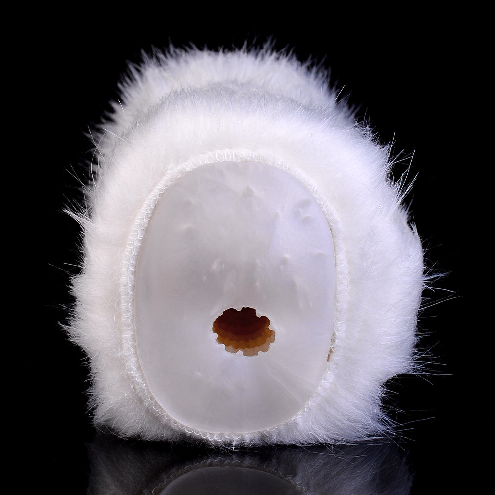 Front view of white furry dual-hole opening with small brown center