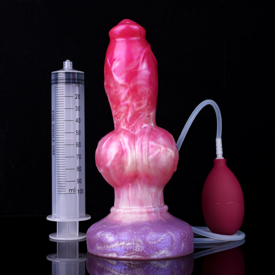 Realistic dog-themed squirting dildo with pink molded body and flexible tube, plus measuring syringe