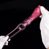 Metallic pink dog penis sleeve with open ring end, gloved hand holding