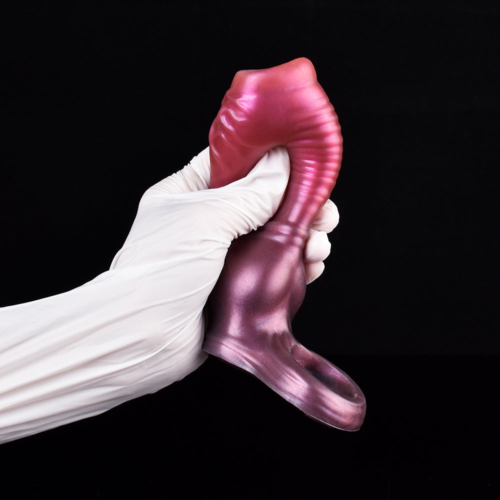 Dog penis sleeve in metallic pink on gloved hands, knot base and front texture