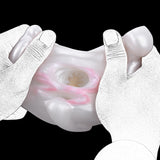 Close-up of white rabbit dual-hole opening with pink inner detail