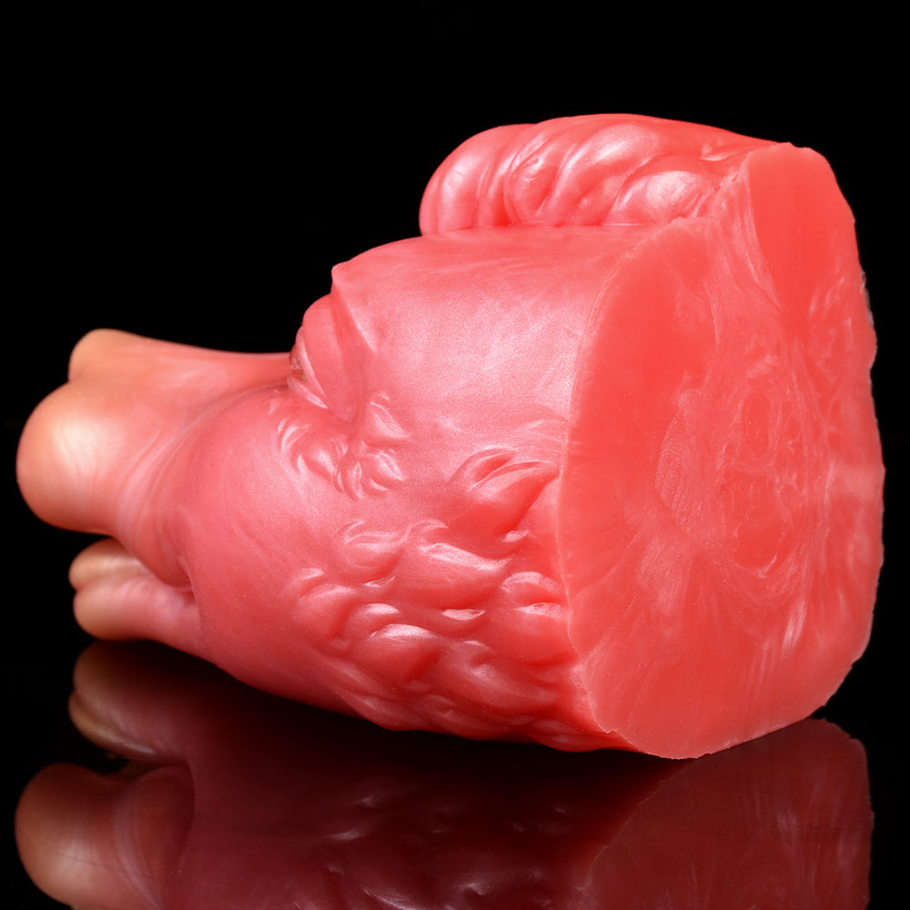 Pink/red creature fleshlite end view with ridged body texture; rounded tail end