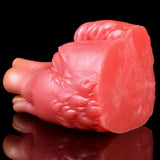 Pink/red creature fleshlite end view with ridged body texture; rounded tail end