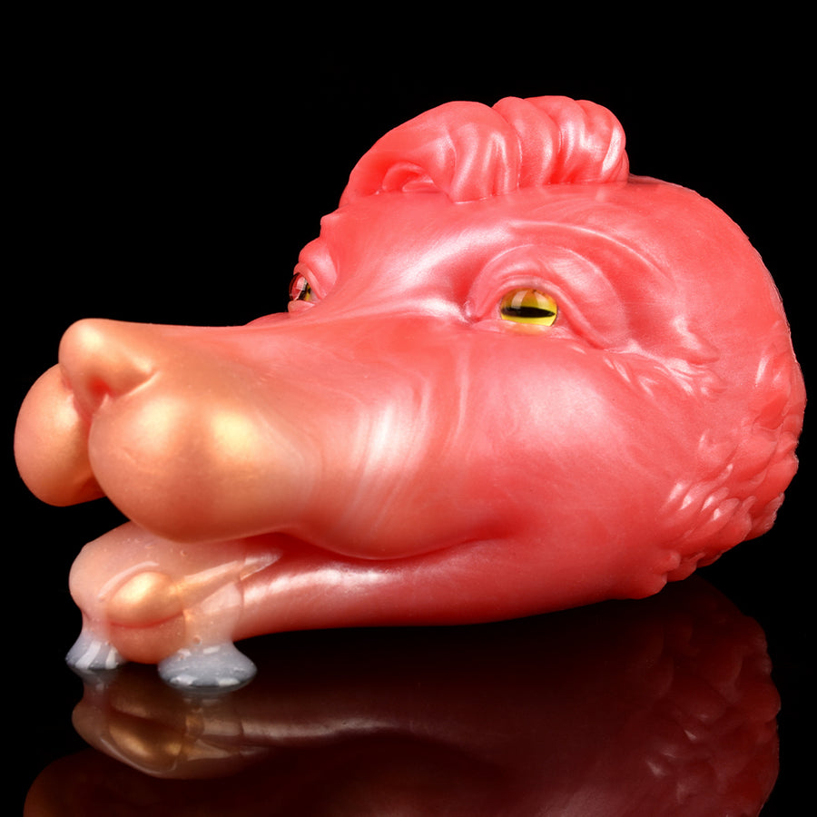 Pink creature fleshlight with molded snout and green eye, showing gray insert tip