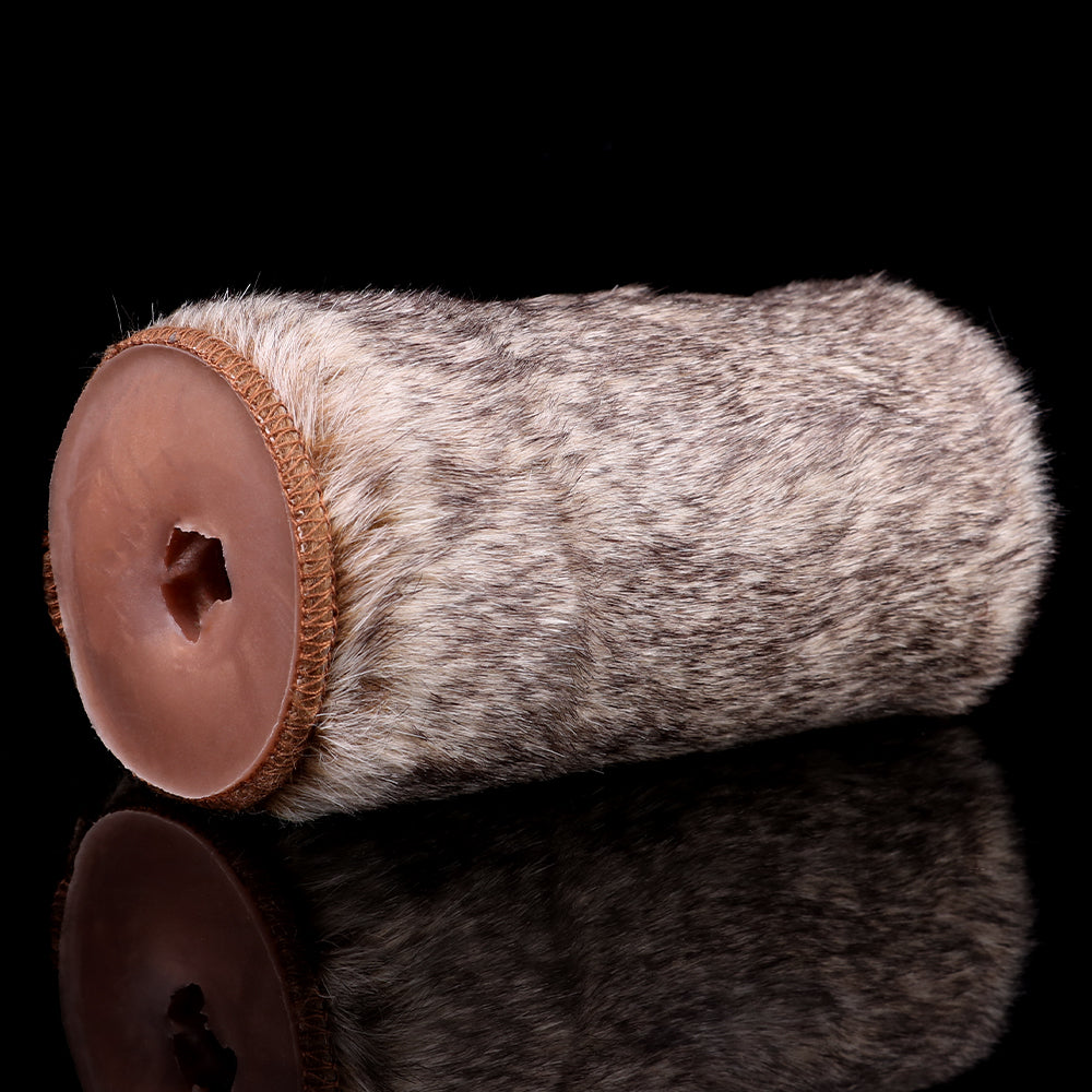 Gray-brown furry stroker with exposed end cap showing dual openings