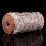 Gray-brown furry stroker with exposed end cap showing dual openings