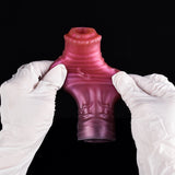 Metallic pink silicone horse cock sleeve held from sides, open tip visible