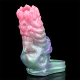 Cock sleeve extender angled view; pink top fades to purple and mint with a textured surface
