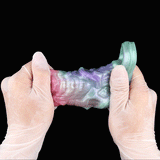 Hands holding cock sleeve extender centered; iridescent pink, purple and mint textured sleeve