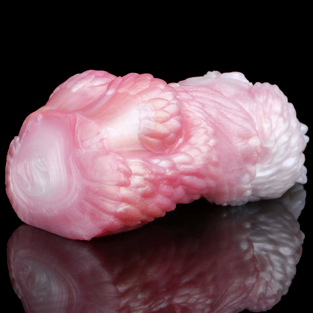 Close-up of squid-shaped fleshlight, pink and white, textured body
