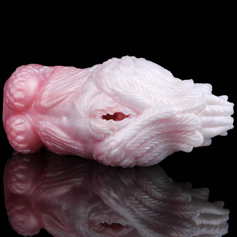 Pink and white fleshlight-style masturbator viewed from side with inner opening