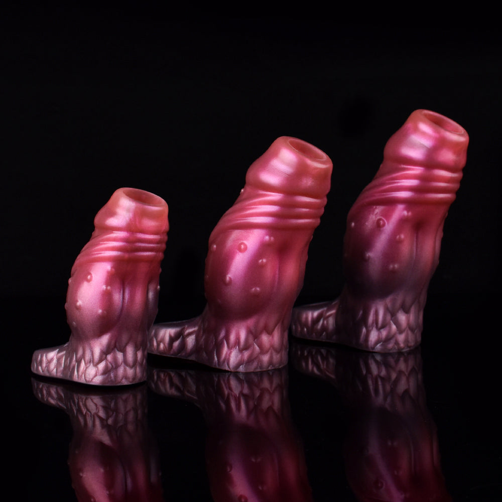 Three pink ribbed dragon-knot extender sleeves, standing upright, scale detail