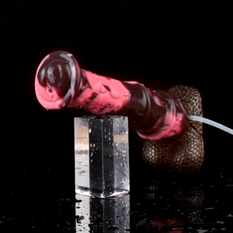 Horse-cock toy producing a pink stream toward a clear cup, brown textured base