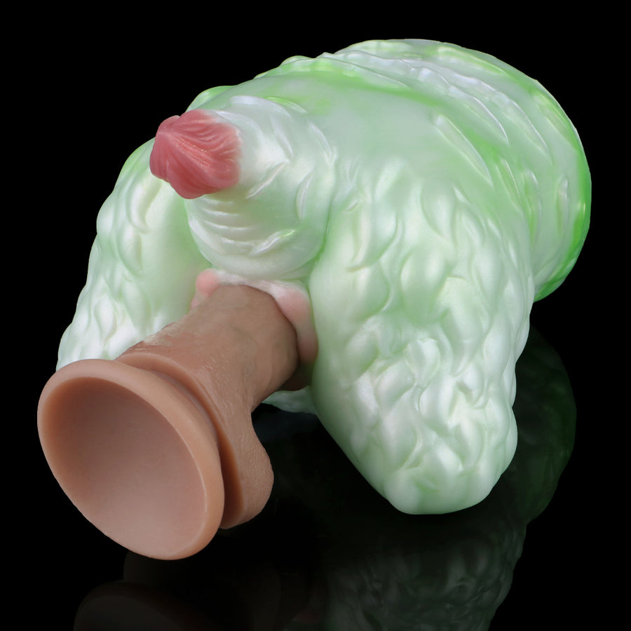 Green silicone butt plug with pink insert tip, hand holding the base, side view.