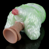 Green silicone butt plug with pink insert tip, hand holding the base, side view.