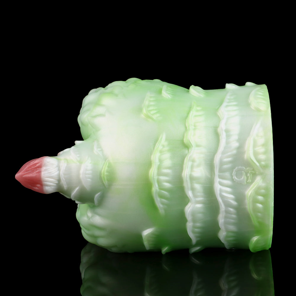 Green silicone butt plug with pink insert tip, rear side view with ribbed texture.