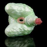 Green silicone butt plug with pink insert tip, angled view showing textured ridges.