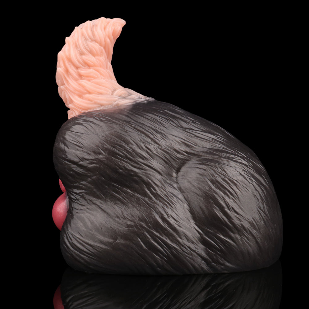 Side view of tailless dog sex toy: black textured body with pale pink top
